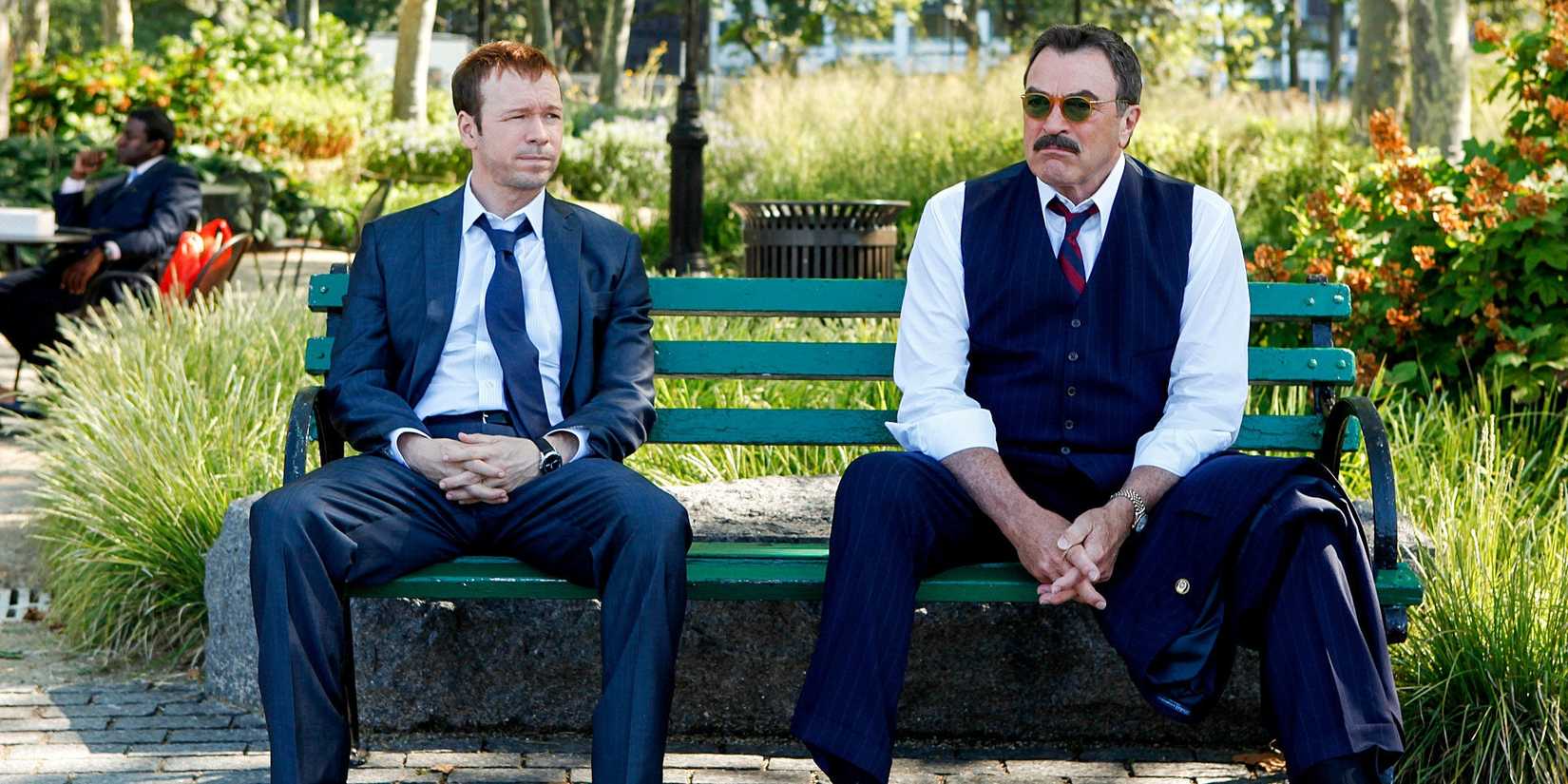 Donnie Wahlberg as Danny and Tom Selleck as Frank sitting on a bench in Blue Bloods