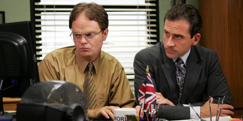 Dwight and Michael looking at a computer, searching Michael's illness symptoms, in The Office.