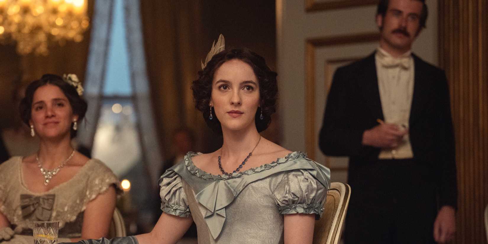 Elizabeth Daulau sitting at a tabe from House of Guinness
