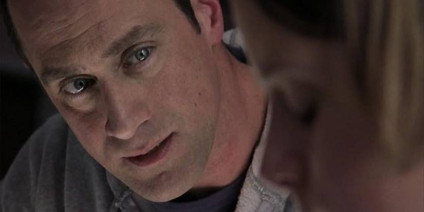 Elliot Stabler in Law and Order SVU looking at blurred figure