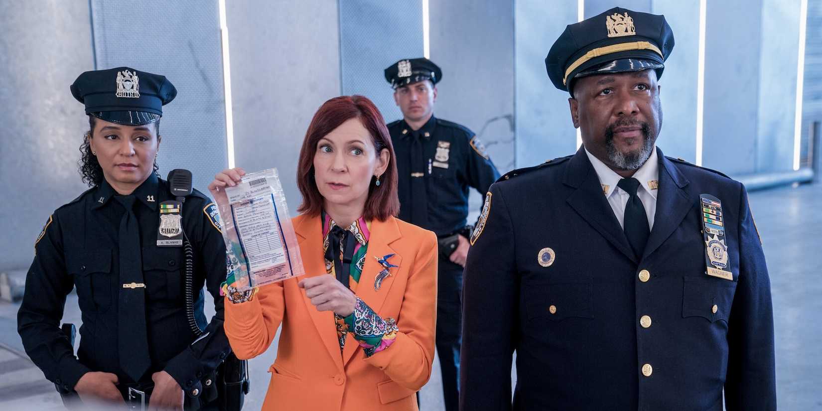 Elsbeth and the police officers hold up a bag of evidence