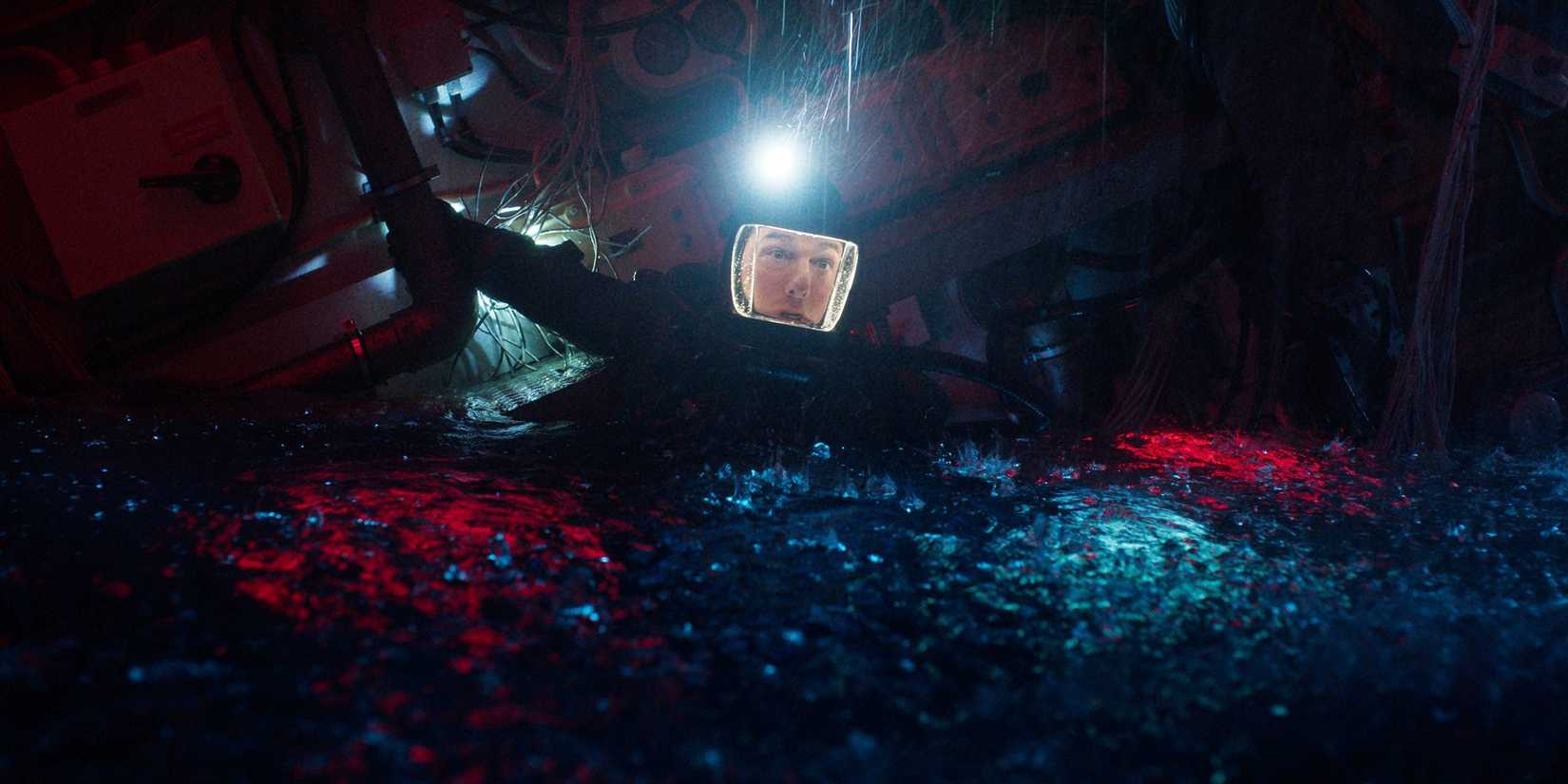 Ethan Hunt looking panicked in an underwater suit while partially submerged in water in Mission Impossible The Final Reckoning