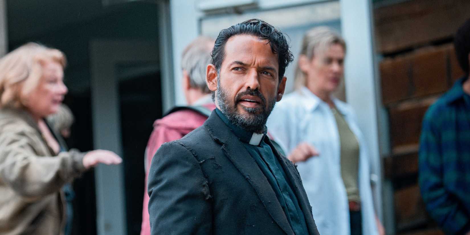 Father Khatri looking back confused in From season 1