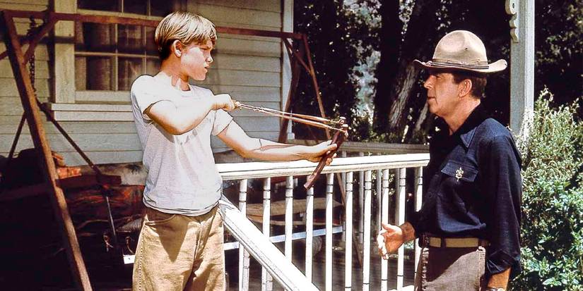 Kurt Russell aims a slingshot at Fred MacMurray in Follow Me, Boys!