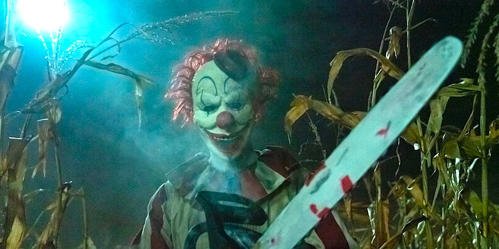 Frendo the clown revs up a chainsaw in a cornfield from Clown in a Cornfield