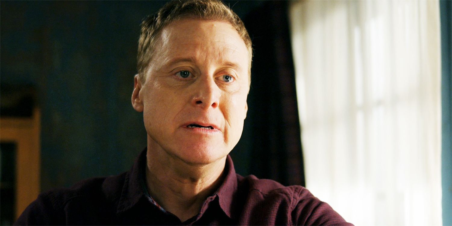 Harry looking sad, after reading a letter, in an episode of Resident Alien