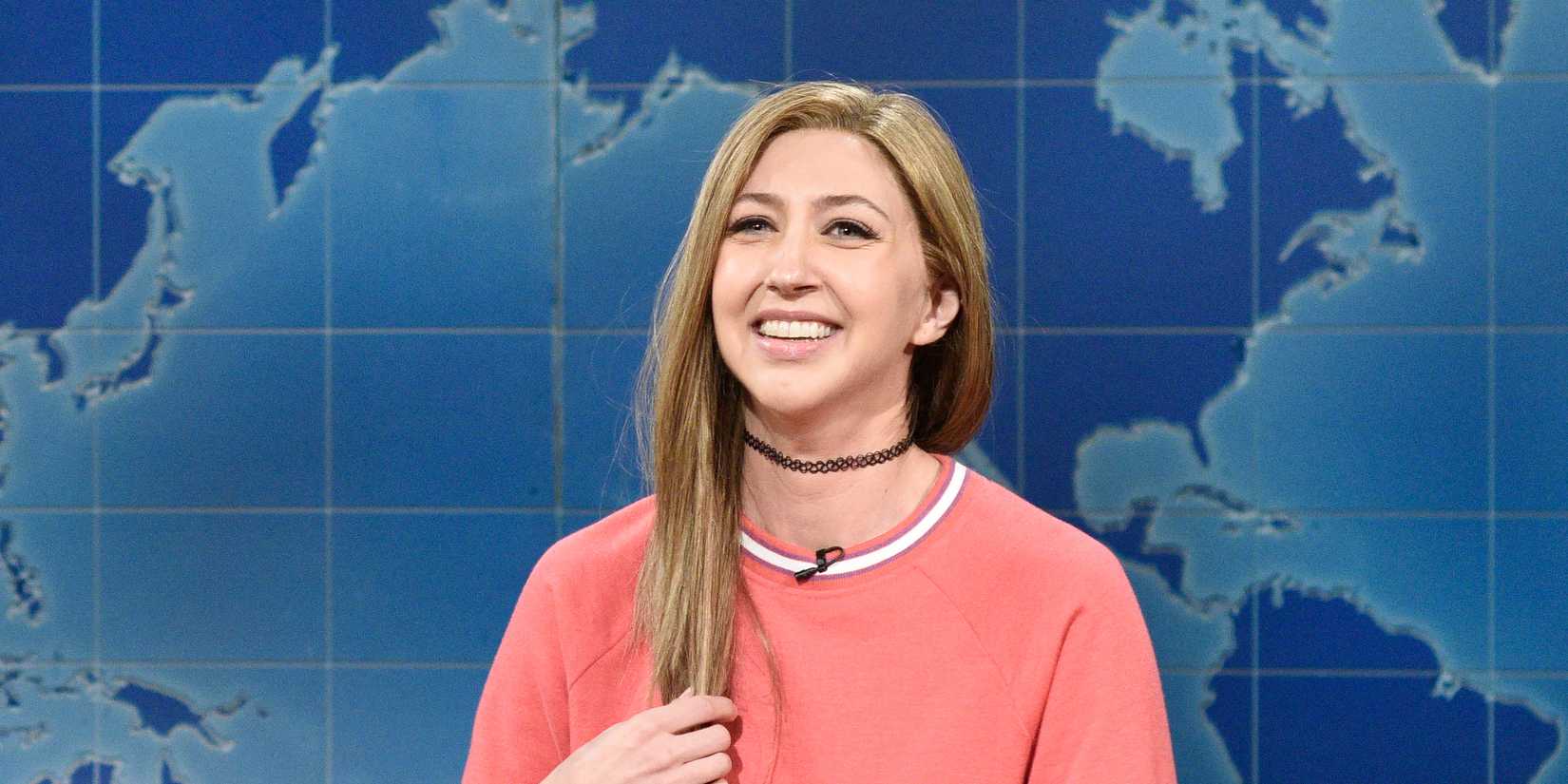 Heidi Gardner smiling on the Weekend Update set from Saturday Night Live