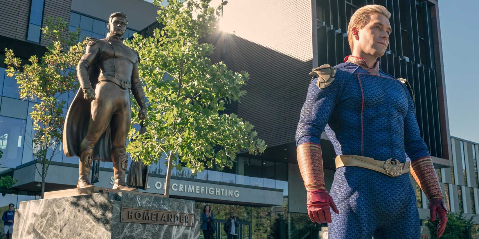 Anthony Starr as Homelander standing in front of a statue of himself outside Godolkin University in Gen V