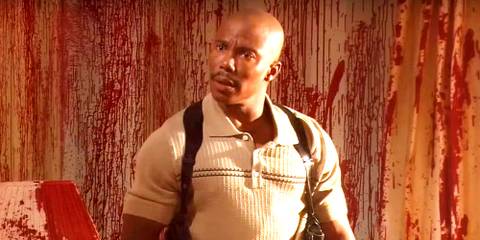James Doakes looking surprised with blood spatter behind him in Dexter