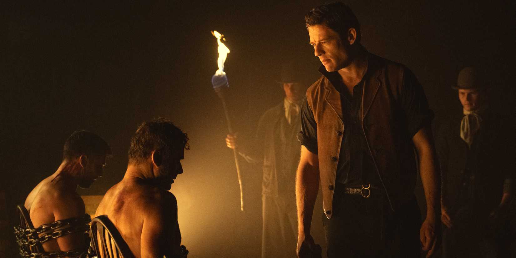 James Norton standing over chained men from House of Guinness