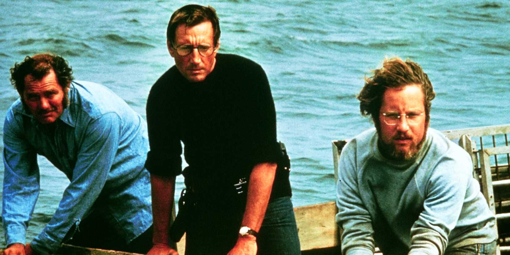 Hooper, Quint, and Brody look on in astonishment on the deck of the Orca in Jaws