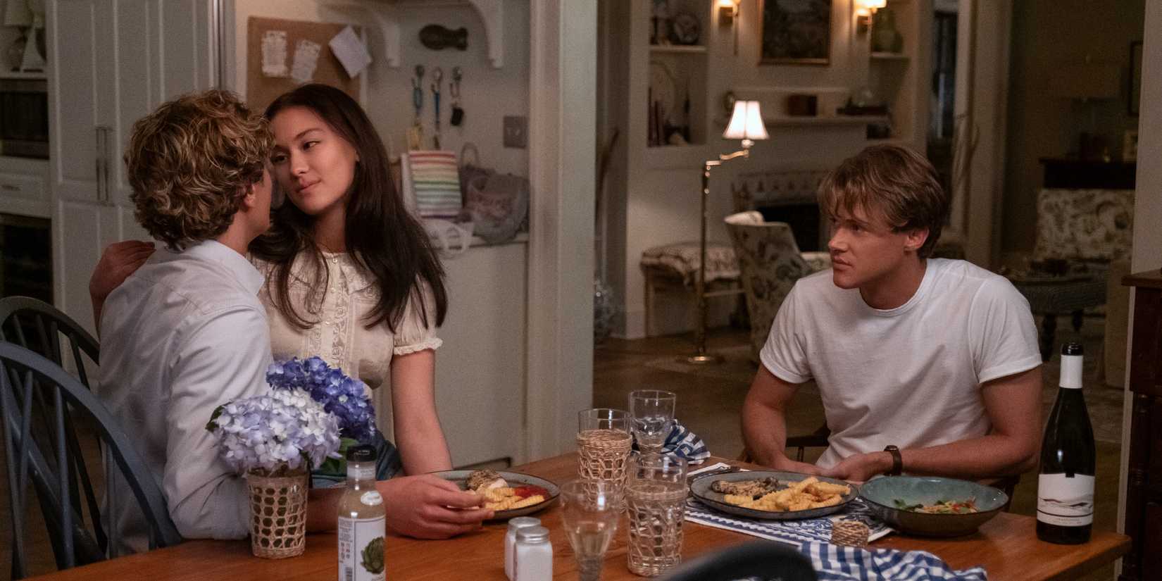 Jeremiah, Belly, and Conrad sitting at a table in The Summer I Turned Pretty season 3