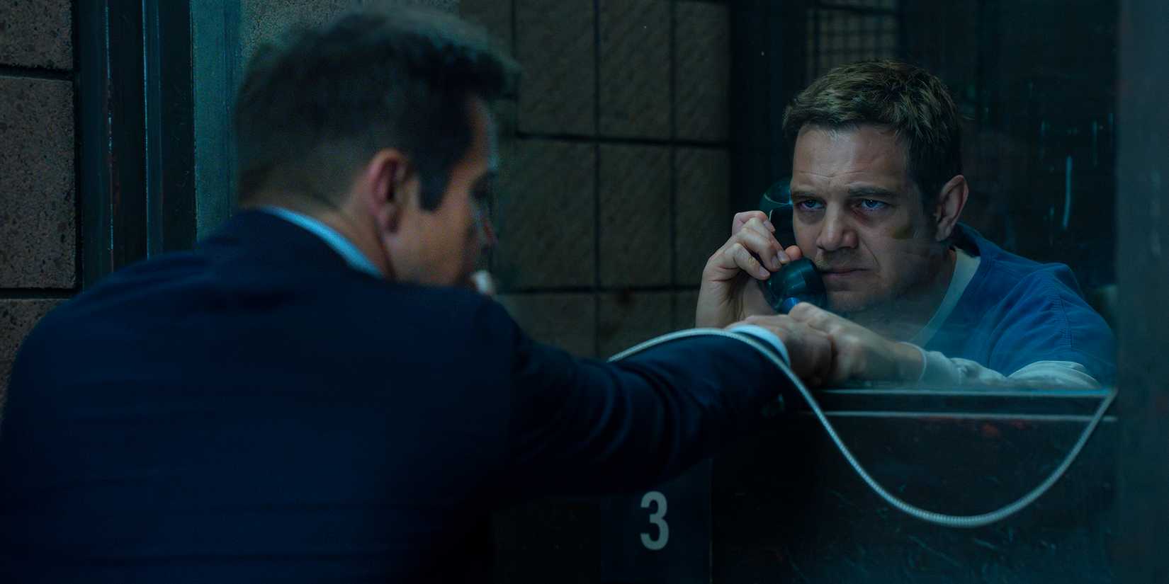 Jeremy Renner's Mike and Taylor Handley's Kyle fistbumping through prison glass in Mayor of Kingstown season 4