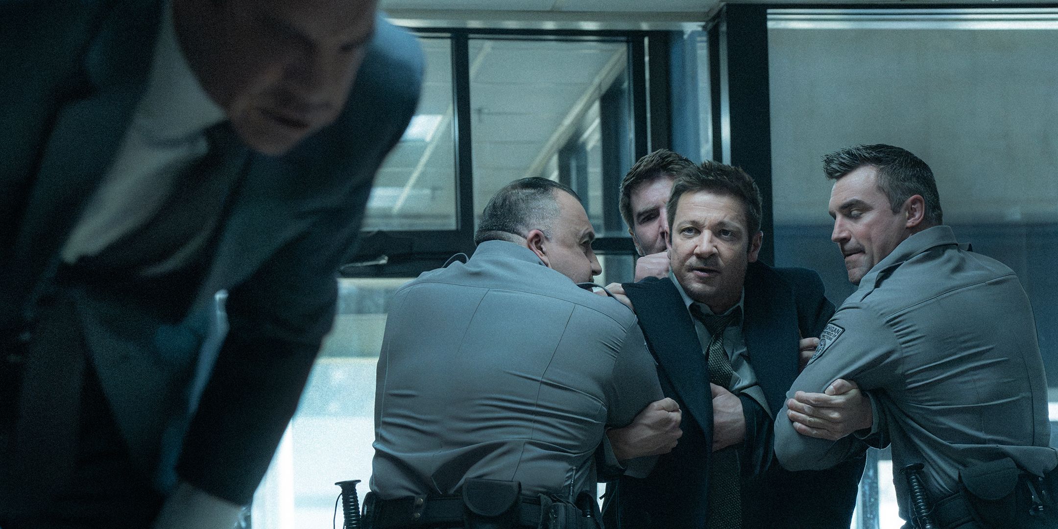 Jeremy Renner's Mike being held back by multiple officers in Mayor of Kingstown season 4