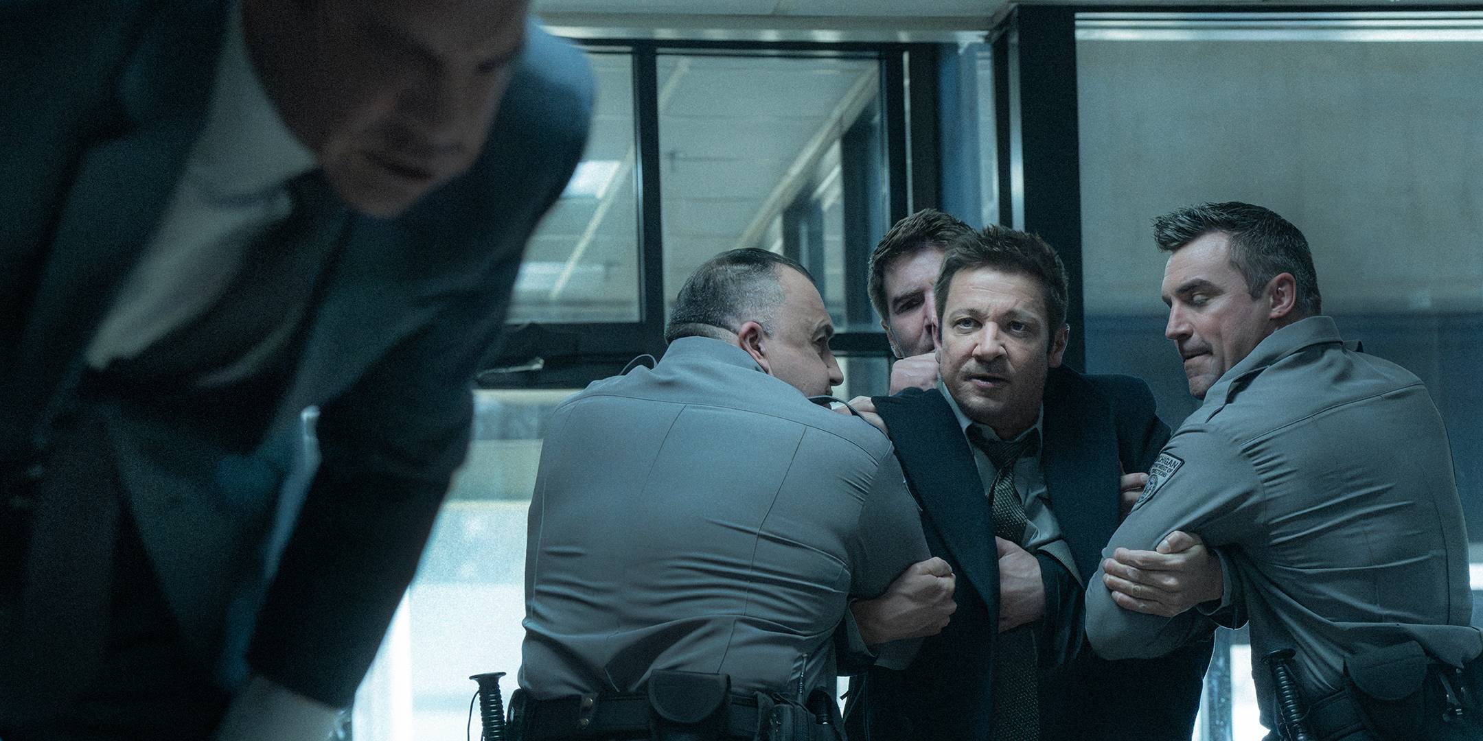 Jeremy Renner's Mike being held back by multiple officers in Mayor of Kingstown season 4