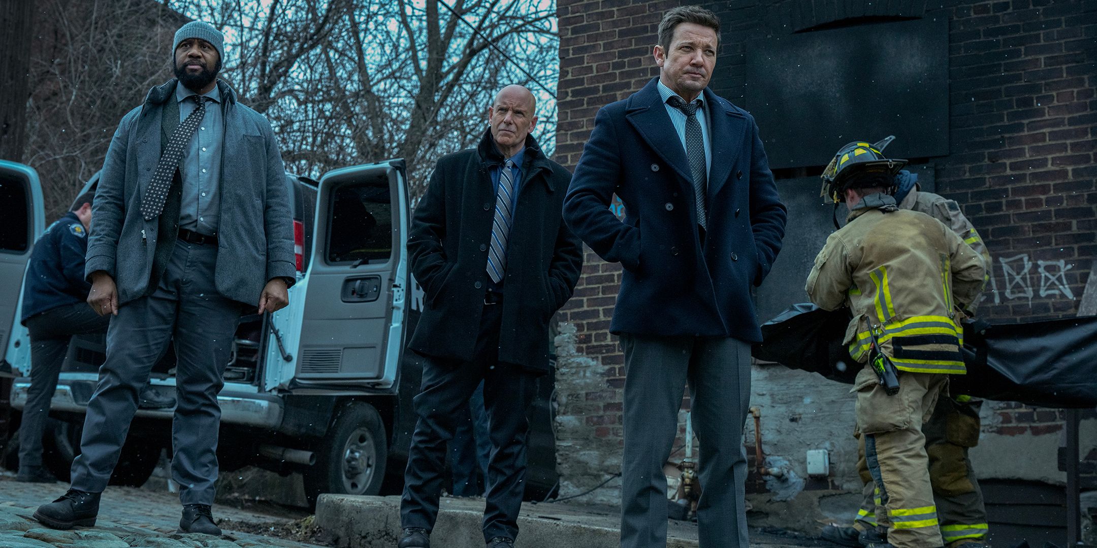 Jeremy Renner's Mike walking away from a burned-out building in Mayor of Kingstown season 4