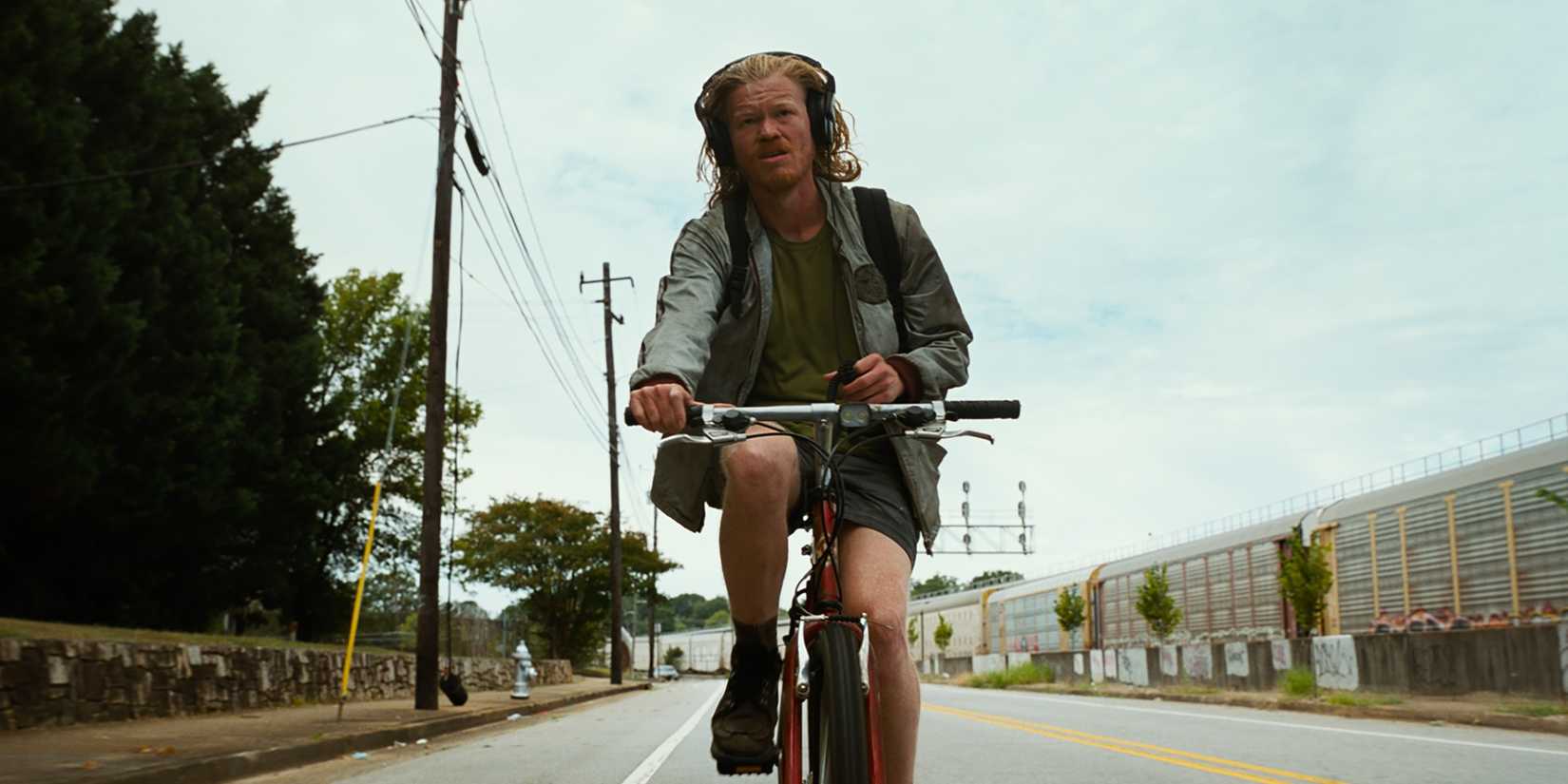 Jesse Plemons riding a bike in Bugonia
