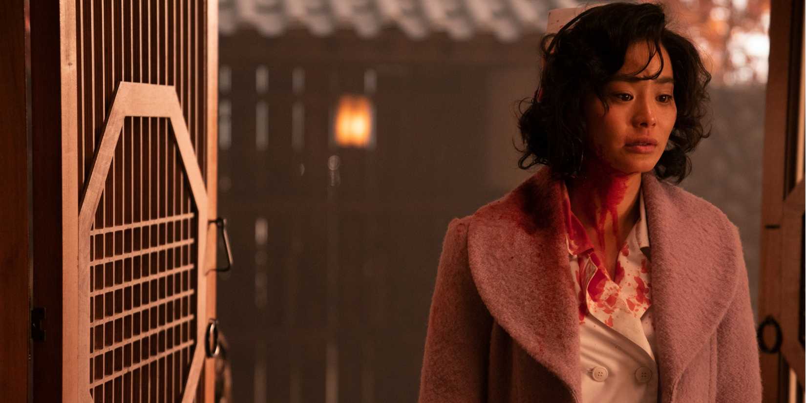 Ji-Ah (Jamie Chung) with blood on her neck looking traumatized in Lovecraft Country