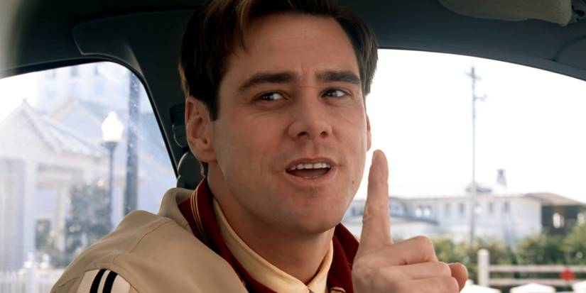 Jim Carrey as Truman holding up a finger in The Truman Show
