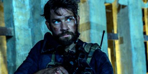 John Krasinski looking serious with a rifle as Jack Silva in 13 Hours The Secret Soldiers of Benghazi