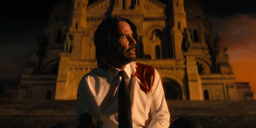 John Wick looking at the sunrise in John Wick 4