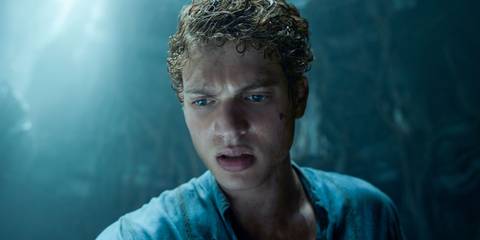 Josha Stradowski as Rand al'Thor looking down at something off screen, confusion in his eyes, in The Wheel of Time
