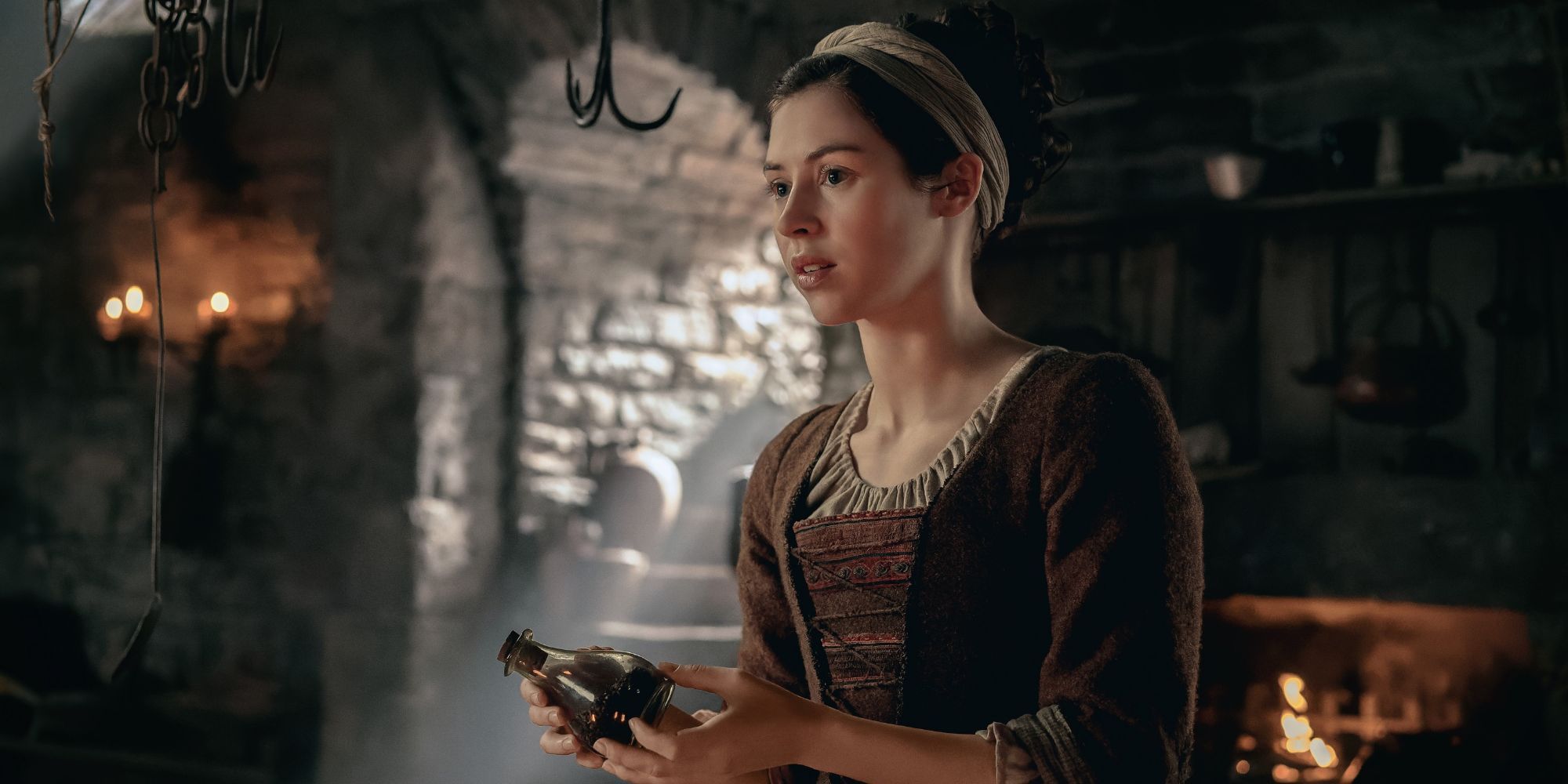 Julia holding a bottle in Outlander Blood of My Blood