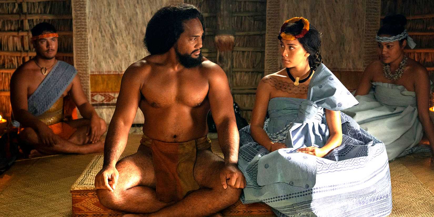 Kaina Makua's Kamehameha and Luciane Buchanan's Kaʻahumanu looking at each other while seated in Chief of War