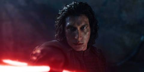 Kylo Ren pointing his red lightsaber toward the viewer in The Rise of Skywalker