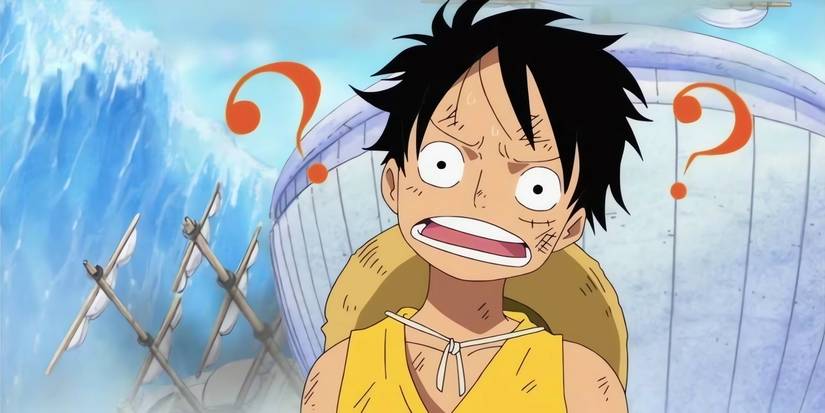 Luffy looking to the front with a confused expression on his face. Behind him, a destroyed ship can be seen. 