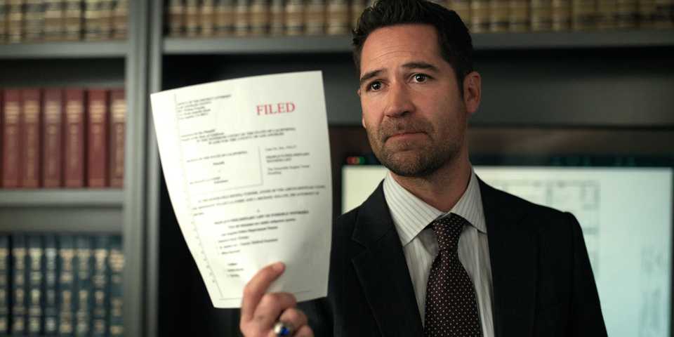 Manuel Garcia-Rulfo as Mickey Haller in The Lincoln Lawyer season 3, episode 6, holding up a paper