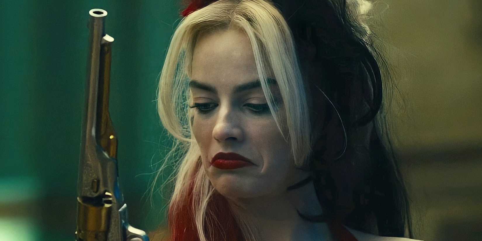 Margot Robbie's Harley Quinn checks her revolver in The Suicide Squad
