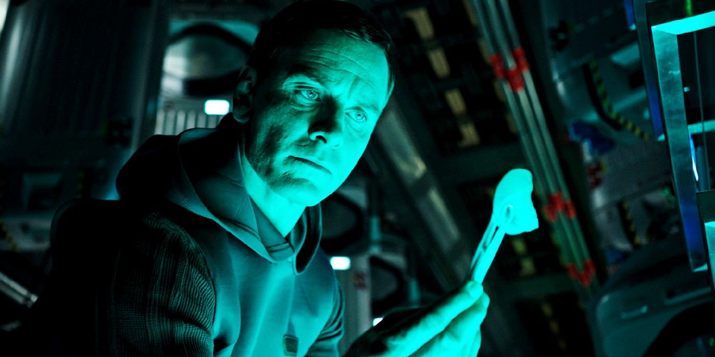 Michael Fassbender examining something in Alien Convenant