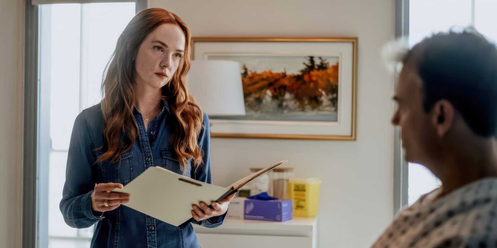 Morgan Kohan as Maggie Sullivan holding a patient chart in Sullivan's Crossing