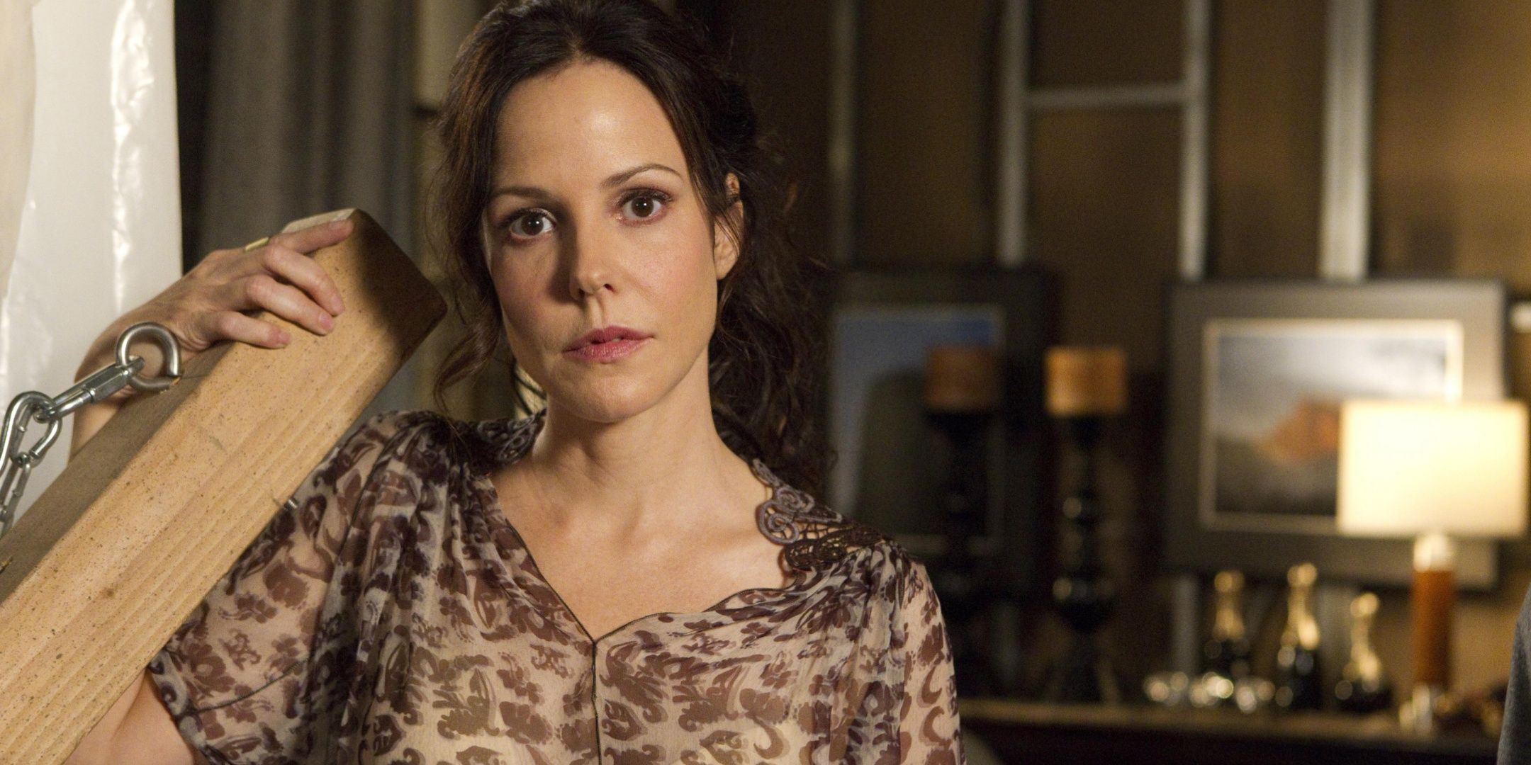 Nancy Botwin (Mary Louise Parker) holding a block of wood in Weeds