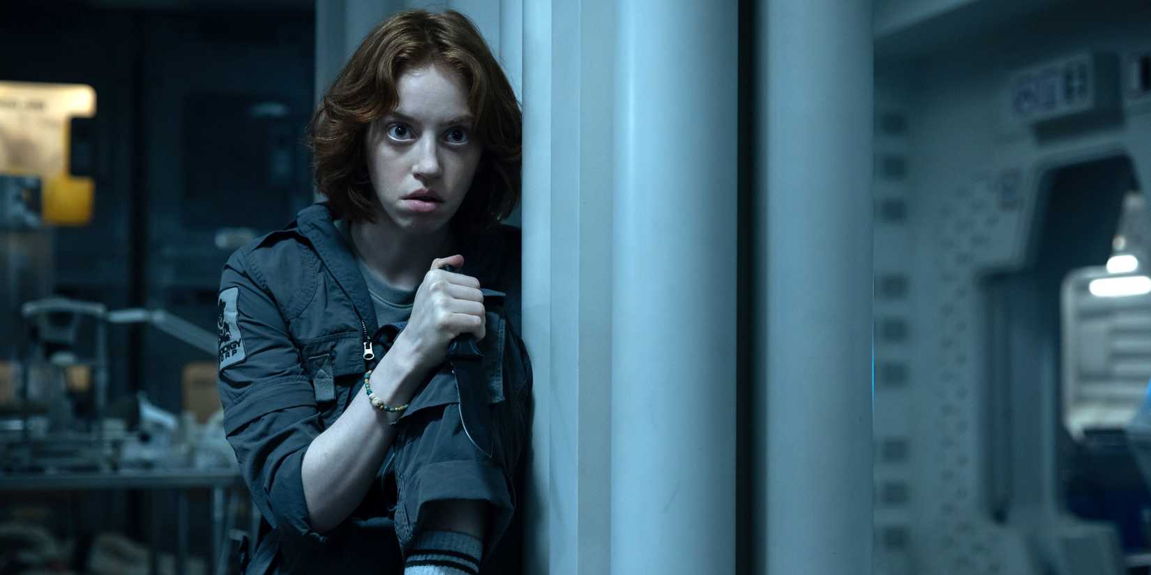 Nibs (Lily Newmark) looking scared while holding a knife in Alien: Earth season 1