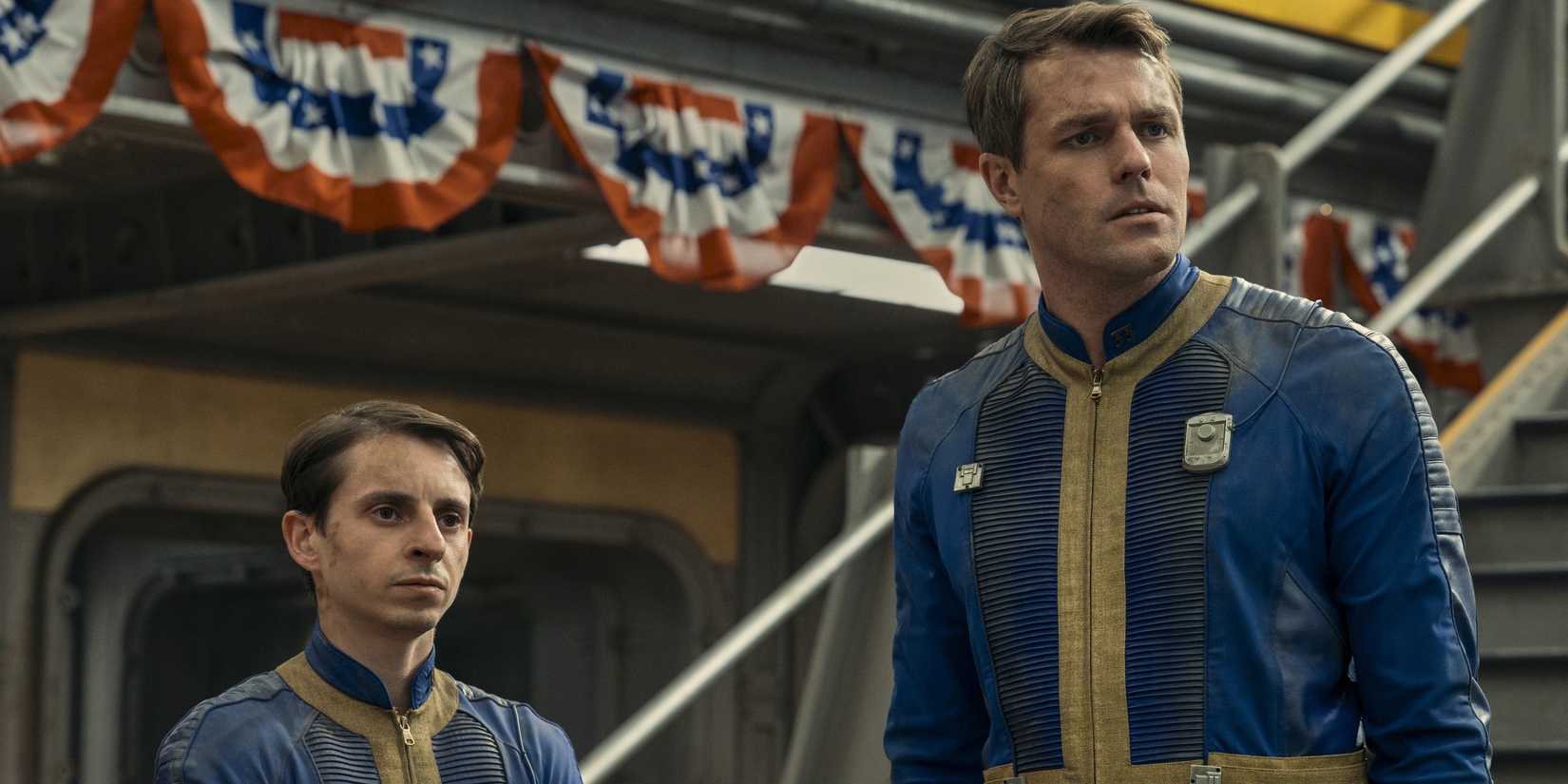 Norm (Moisés Arias) e Chet (Dave Register) com ar de preocupação dentro do Vault 33 em Fallout