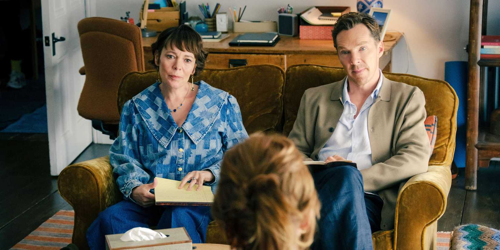 Olivia Colman and Benedict Cumberbatch sitting on a couch staring at a therapist in The Roses