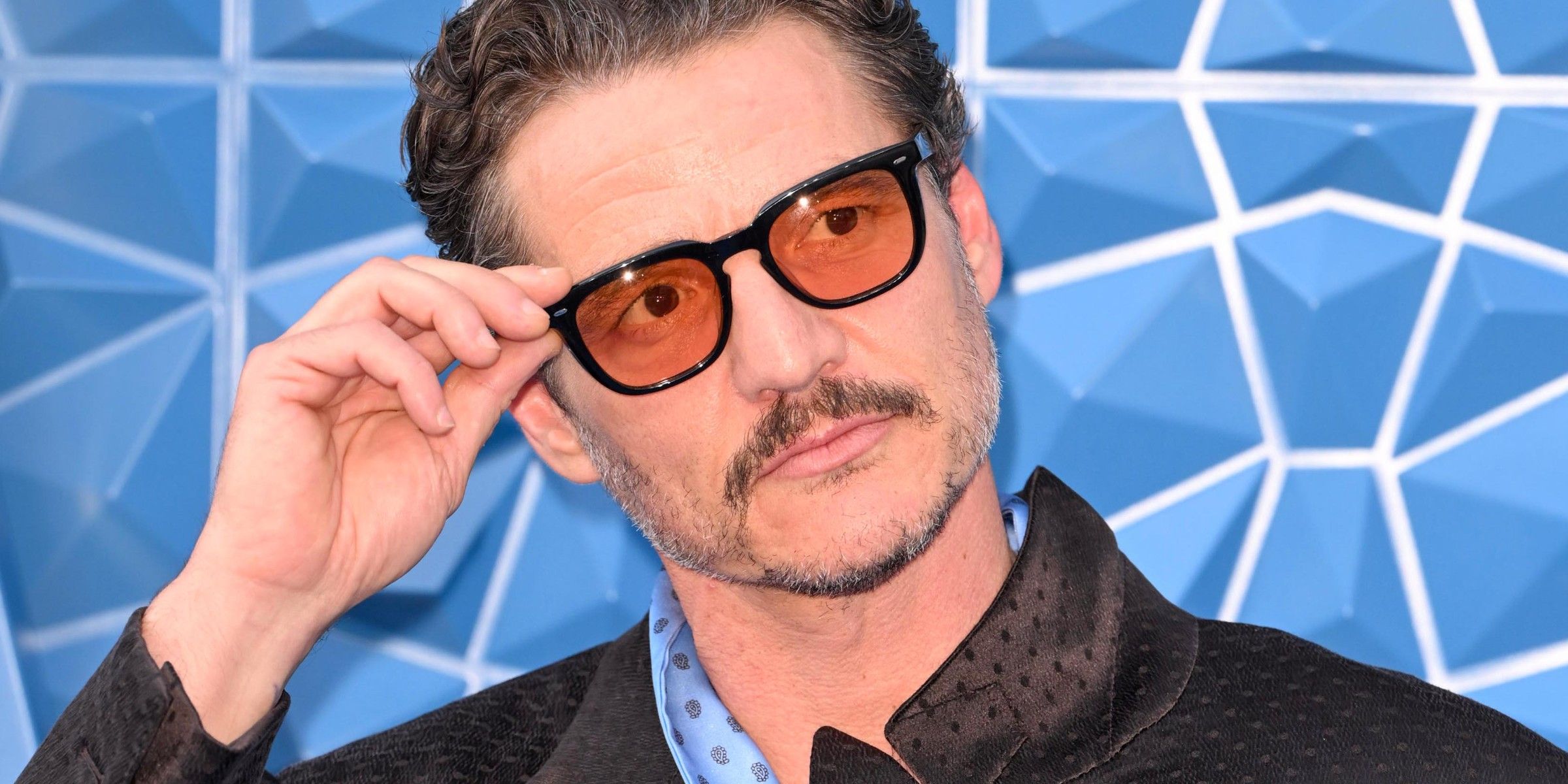 Pedro Pascal fixing his glasses at the premiere of Fantastic Four First Steps