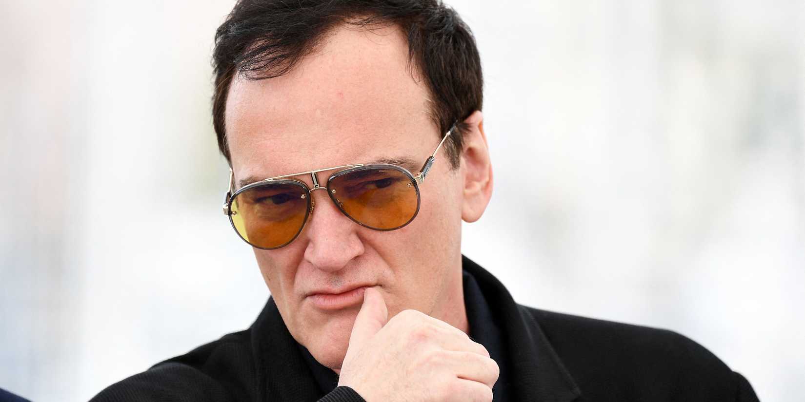 Quentin Tarantino peers forward intently while attending an event