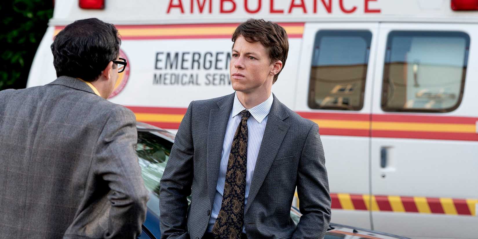 Milo Callaghan's Rudy Baylor talking to PJ Byrne's Deck in front of an ambulance in The Rainmaker season 1, episode 1.