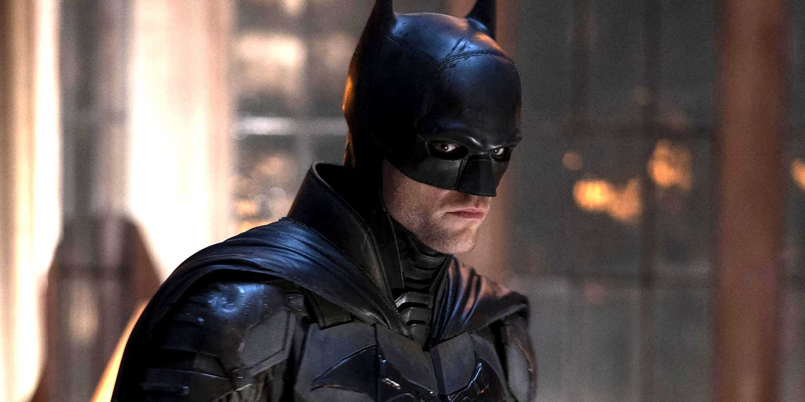 Robert Pattinson as Batman looking intensely at something in The Batman
