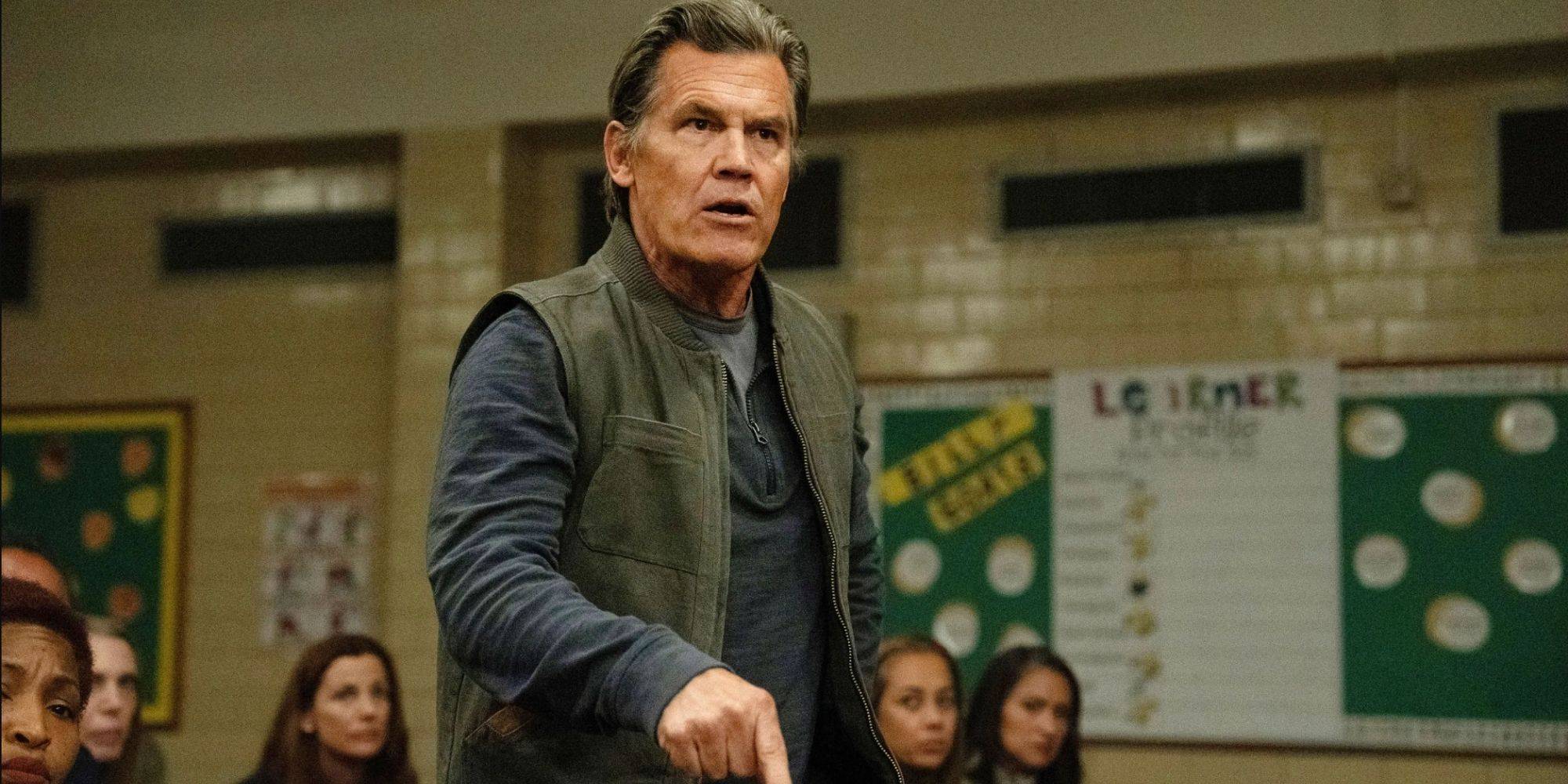 Josh Brolin as Archer Graff looking angry at a community meeting in Weapons