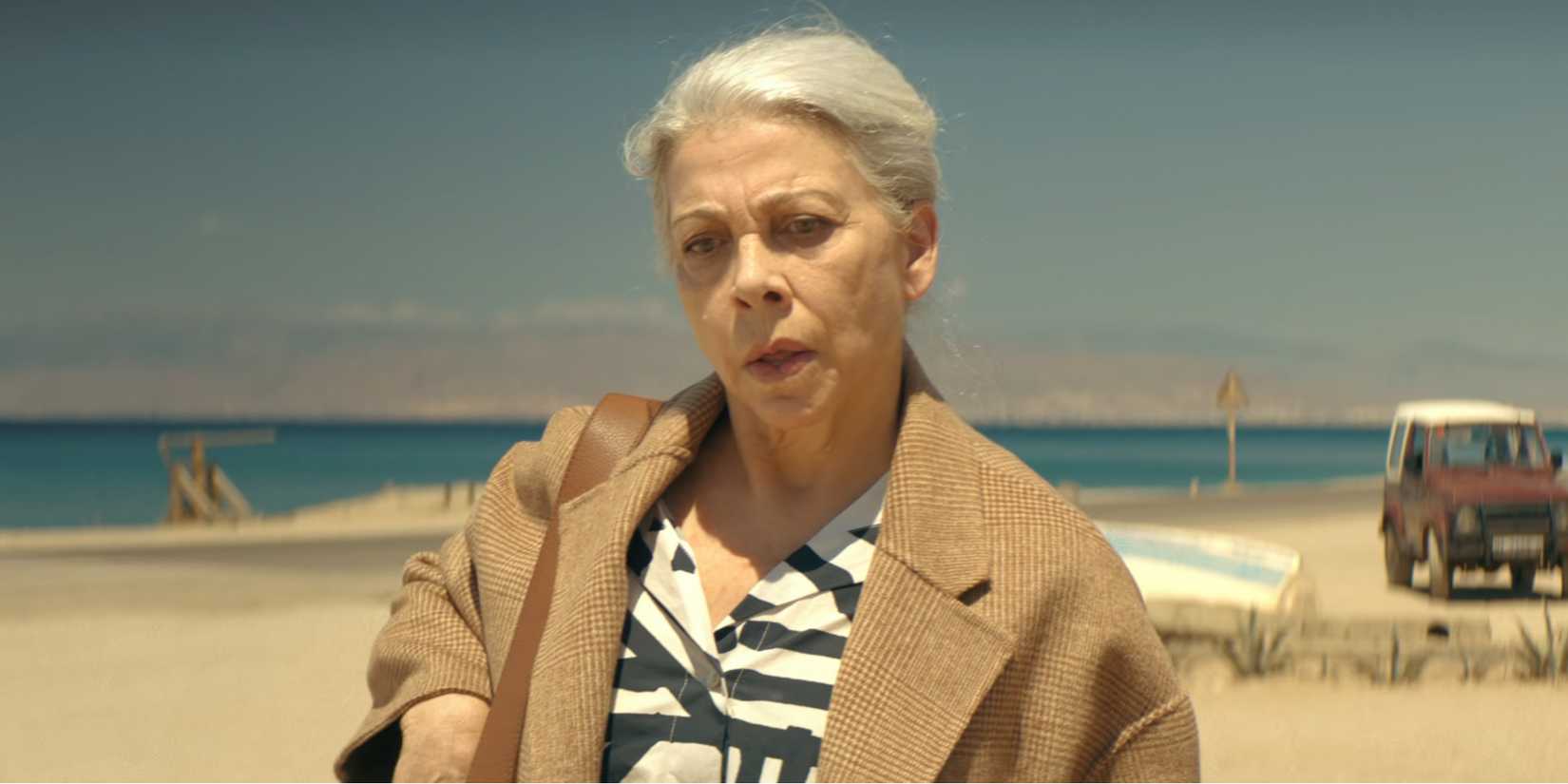 Kiti Mánver as Isabel looks determined on a beach in Two Graves