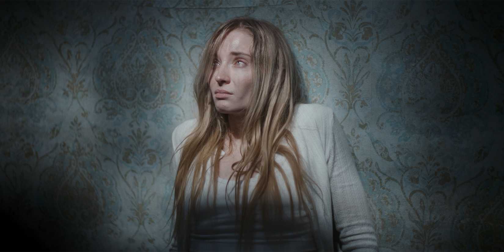 Sophie Turner in a wallpapered room in Trust
