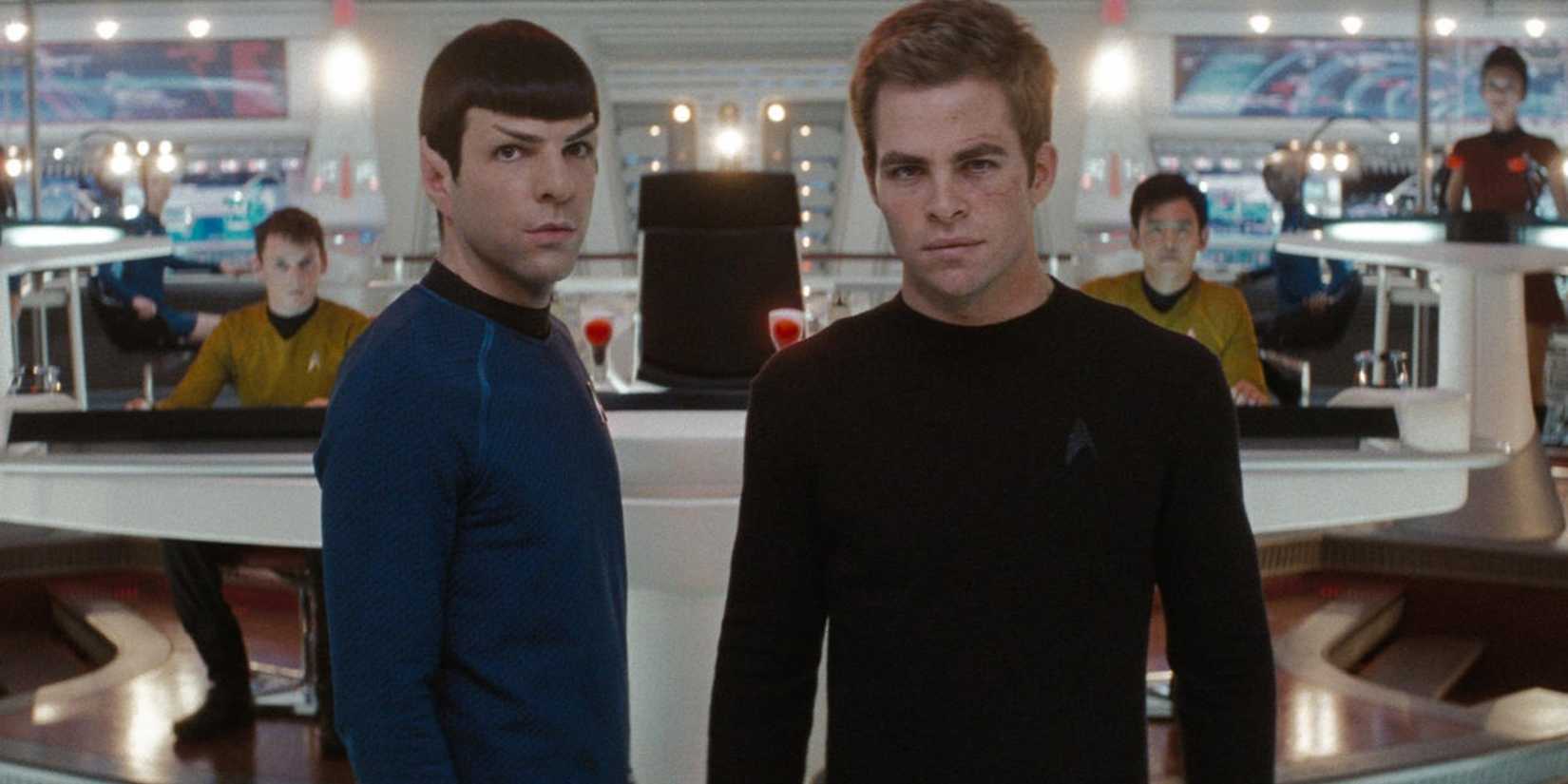Kirk and Spock look toward the view screen as the rest of the crew watches in Star Trek 2009