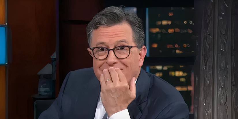 Stephen Colbert covers his mouth in shock and glee after accidentally calling The Late Show by the wrong name, The Colbert Report