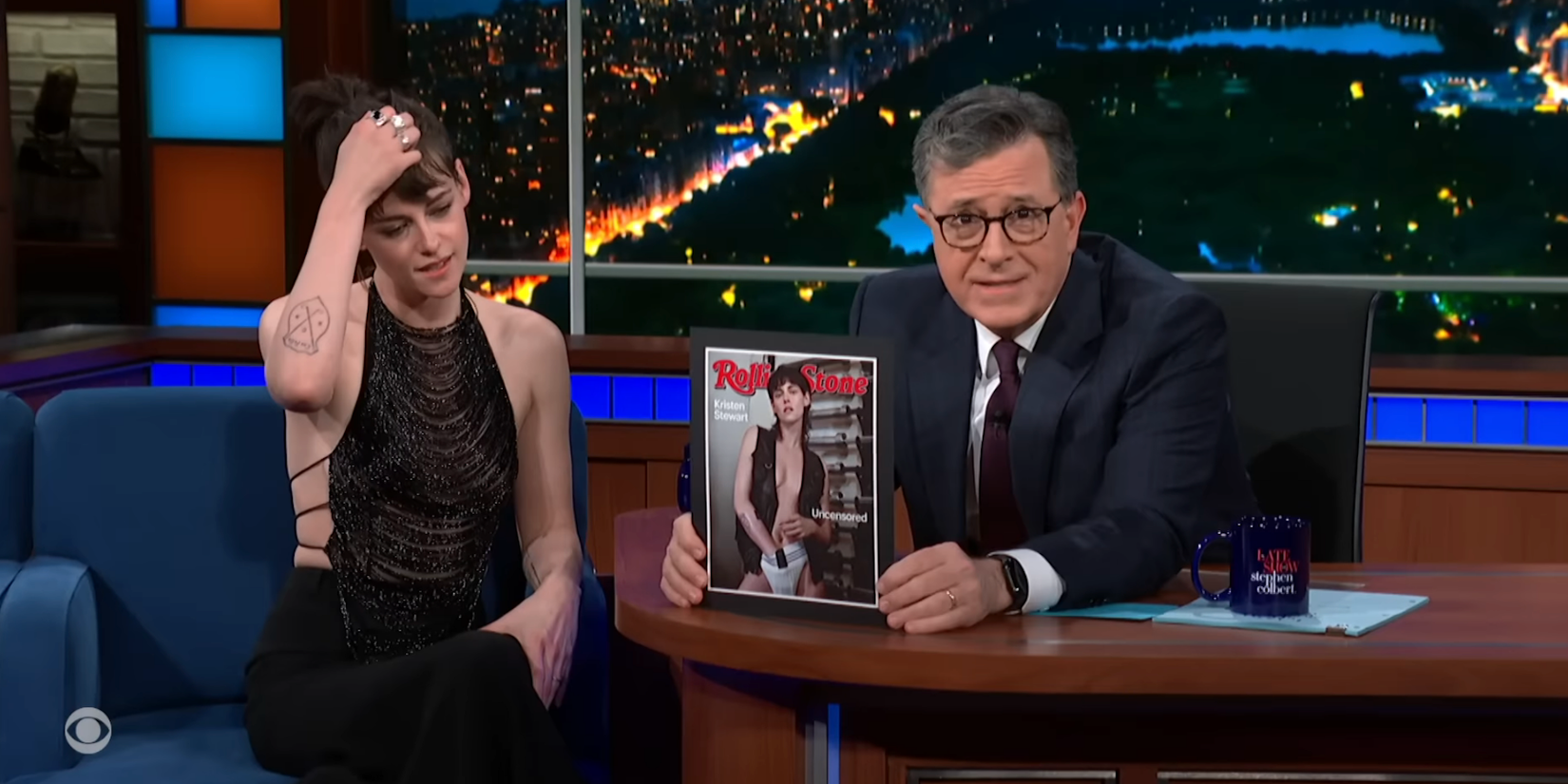 Stephen Colbert holds up Kristen Stewart's Rolling Stone cover while interviewing her on The Late Show