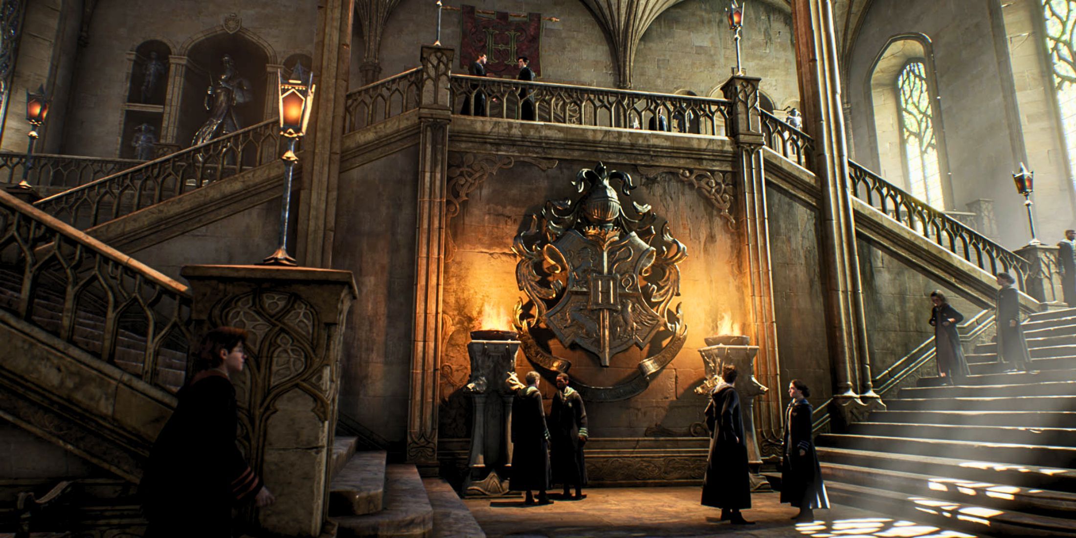 Students gathered at the base of the stairs in Hogwarts in front of the school crest in Hogwarts Legacy (1)