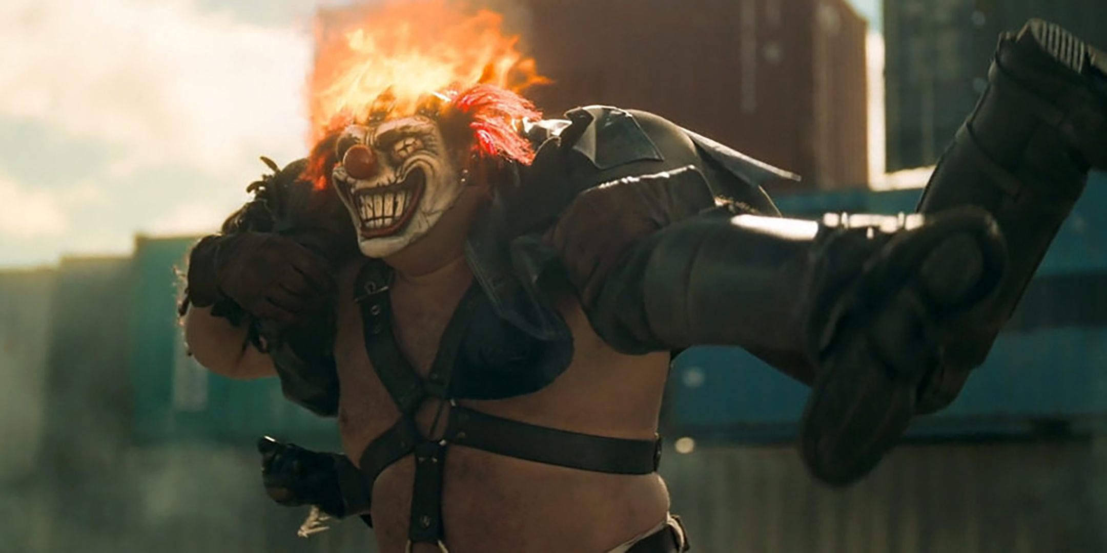 Sweet Tooth holding someone over his shoulders while his head's on fire in Twisted Metal season 2
